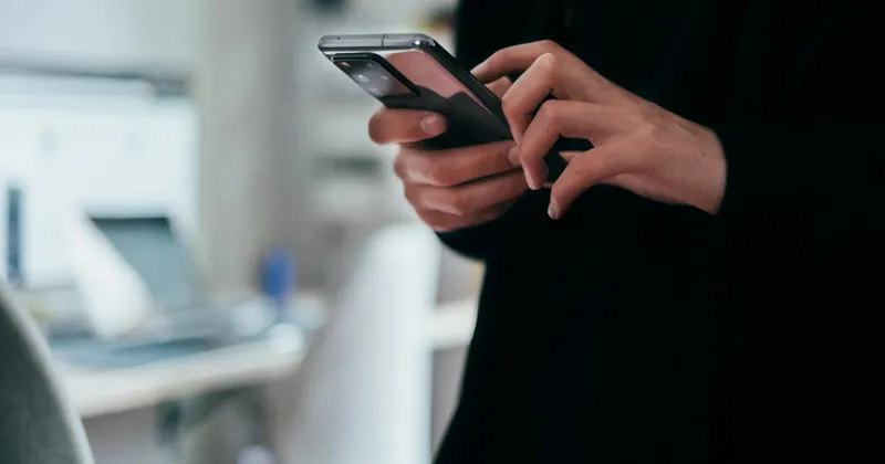 A person reading a message on a smartphone